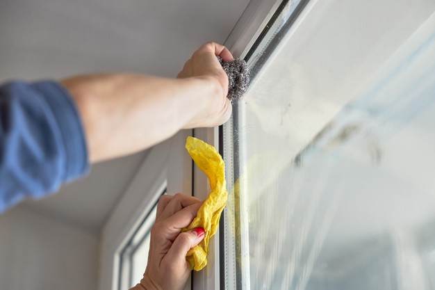 woman cleaning glass window